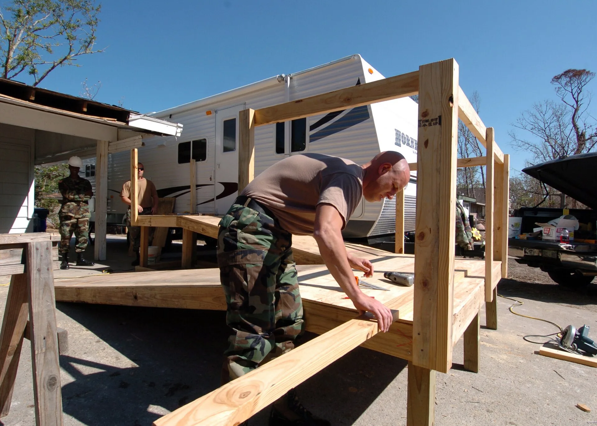 Gulfport, Miss. (Oct. 26, 2005) – A U.S. Navy Instructor assigned to Naval Construction Training Center (NCTC) Gulfport, prepares to measure a piece of lumber for a ramp that will provide easy entry into a travel trailer for a retired Navy Seabee. The Moral, Welfare and Recreation (MWR) department o. Why an Accessible Home Design Timeline Slips