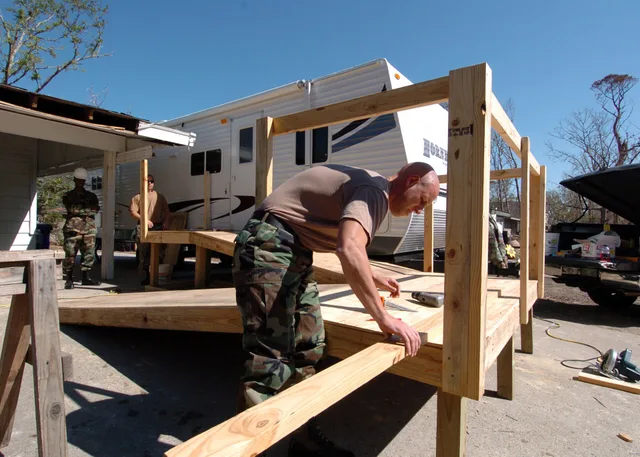 Gulfport, Miss. (Oct. 26, 2005) – A U.S. Navy Instructor assigned to Naval Construction Training Center (NCTC) Gulfport, prepares to measure a piece of lumber for a ramp that will provide easy entry into a travel trailer for a retired Navy Seabee. The Moral, Welfare and Recreation (MWR) department o. Why an Accessible Home Design Timeline Slips