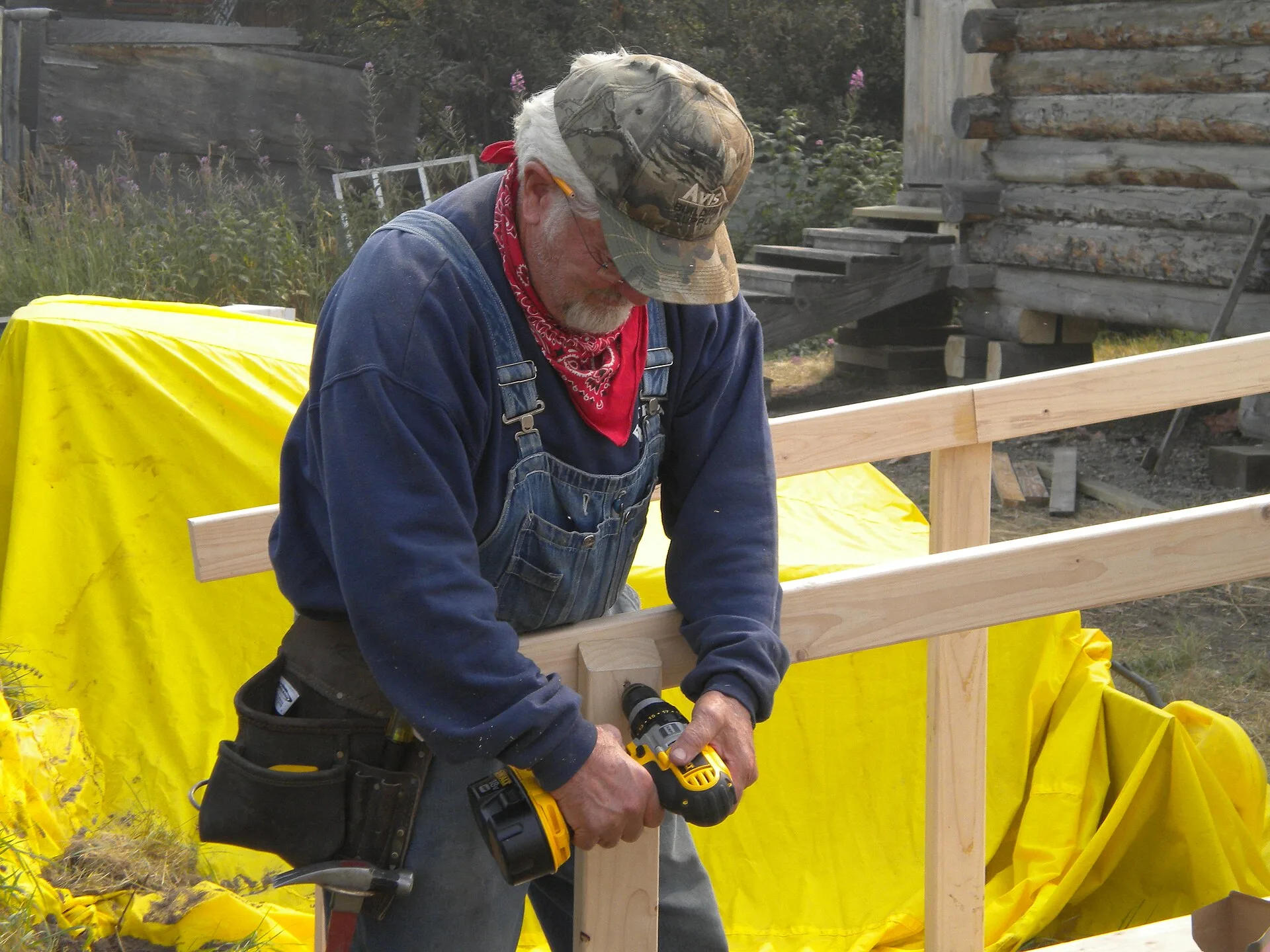Stevens Village, AK, August 4, 2009 -- Amos Diener, Mennonite Disaster Service volunteer, drills a handrail on a new handicap ramp for a home damaged by flood waters. The handicap ramp became necessary because Amos and his fellow volunteer raised the house two feet to prevent future flood damage. -. Adapt in place, move, build an annex or use supported housing: four paths to an accessible home