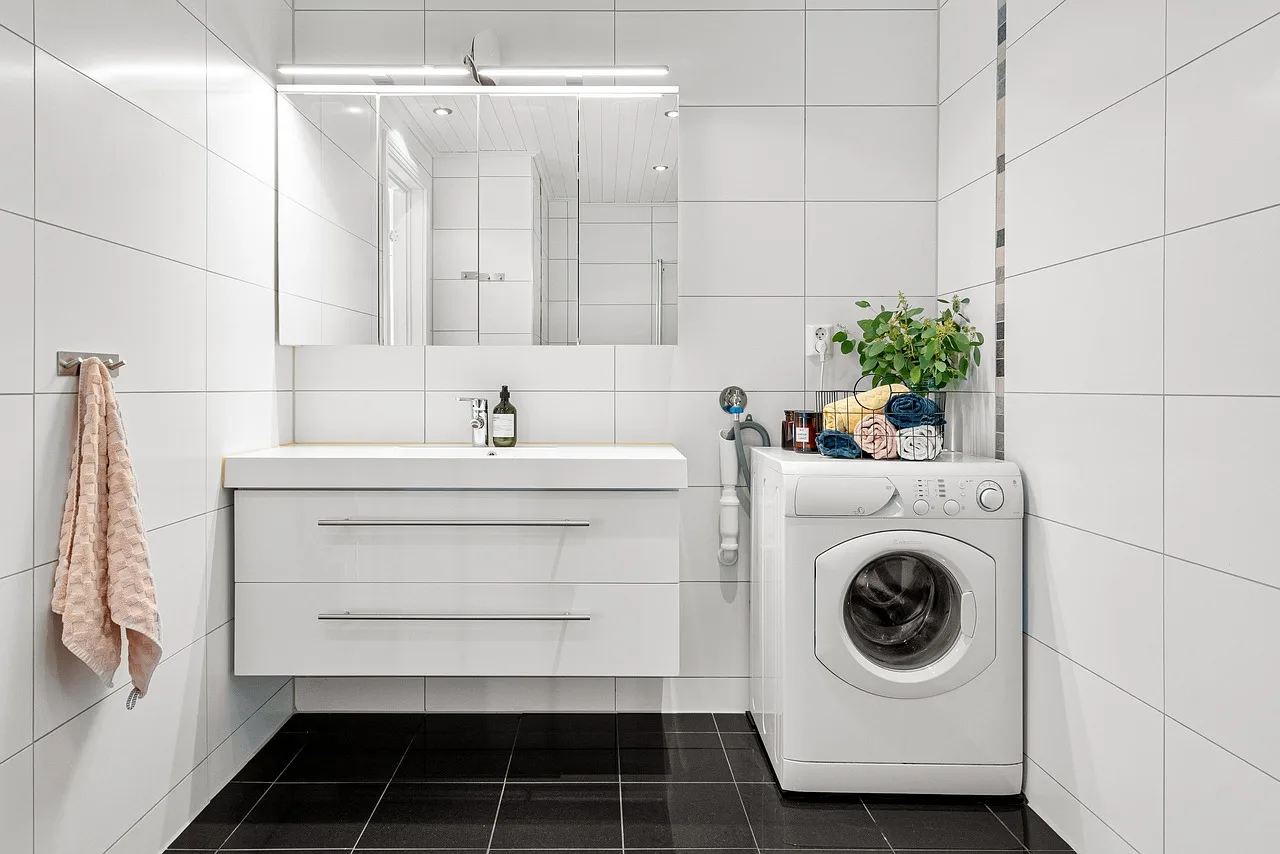 real estate, interior, bath room, toilet, shelf, nature, sink, luxury, art, table, wood, chair, shampoo, shower, washing machine, mirror, towel, decor, cabinet, plant, carpet. Accessible Laundry Room Sink and Counter Heights: A Measuring Guide